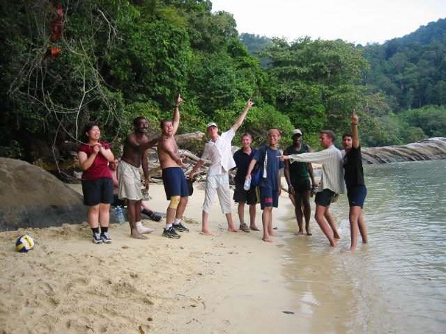 Arms in the air at the water's edge on Tioman