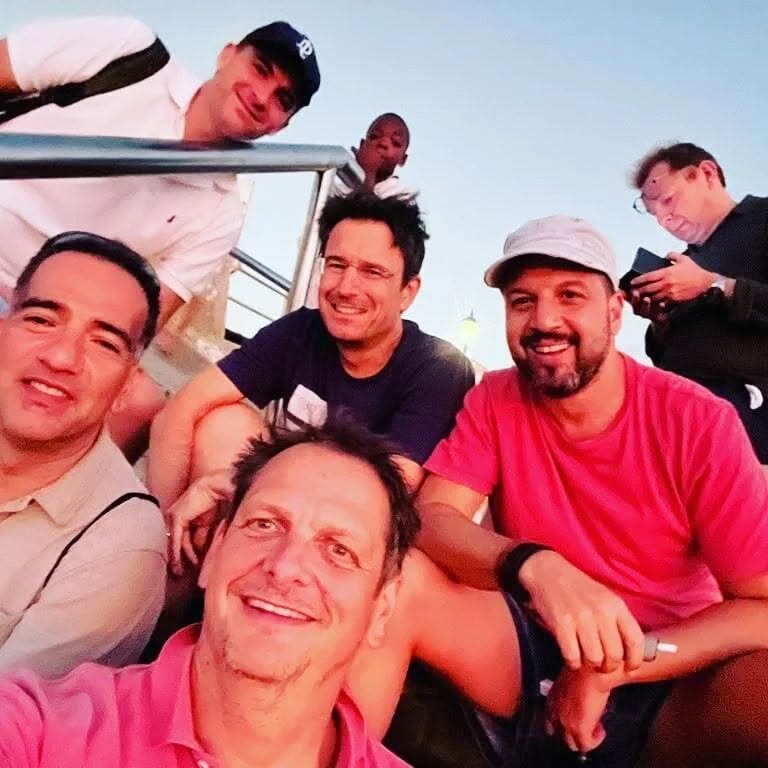 A boat selfie of five of us squinting into the sun